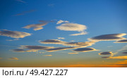 Sunset sky clouds in orange and blue background. Стоковое фото, агентство Ingram Publishing / Фотобанк Лори