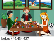 A vector illustration of kids playing puzzles. Стоковая иллюстрация, агентство Ingram Publishing / Фотобанк Лори