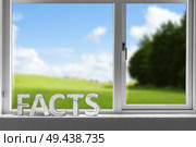 Facts decor sign in a window with a green meadow in the background. Стоковое фото, агентство Ingram Publishing / Фотобанк Лори