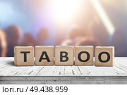Taboo sign on a table in a night club with lights and people. Стоковое фото, агентство Ingram Publishing / Фотобанк Лори