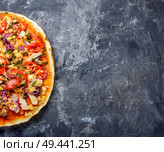 Fresh pizza with meat,tomatoes and mushrooms.Traditional Neapolitan pizza. Tasty appetizing pizza. Стоковое фото, агентство Ingram Publishing / Фотобанк Лори