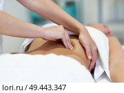 Female patient is receiving treatment by professional osteopathy therapist. Woman having abdomen massage in a physiotherapy center.. Woman having abdomen massage by professional osteopathy therapist. Стоковое фото, агентство Ingram Publishing / Фотобанк Лори