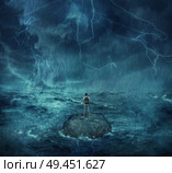 Lost man standing abandoned on a rock island in middle of the ocean, in a stormy night with lightnings in the sky. Looking for help, trying to survive. Adventure, journey and hard determination concept. Стоковое фото, агентство Ingram Publishing / Фотобанк Лори
