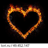 Flaming heart isolated on black background. Love symbol. Стоковое фото, агентство Ingram Publishing / Фотобанк Лори