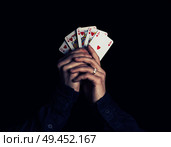 man hands holding playing cards with the strongest combination - royal flush. Стоковое фото, агентство Ingram Publishing / Фотобанк Лори