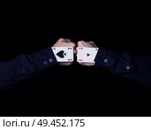 Two fists colide. A pounch of two aces on a black background. Стоковое фото, агентство Ingram Publishing / Фотобанк Лори