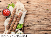 Grilled Lula kebab lamb with sauce.Traditional oriental cuisine.. Shish kebab on a stick. Стоковое фото, агентство Ingram Publishing / Фотобанк Лори