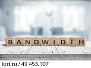 Bandwidth sign in a living room on a wooden desk in bright daylight. Стоковое фото, агентство Ingram Publishing / Фотобанк Лори