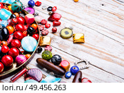 Variety of shapes and colors to make a bead necklace. Colorful beads on wooden surface. Стоковое фото, агентство Ingram Publishing / Фотобанк Лори