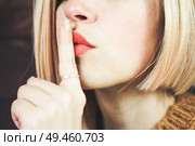  Close up of a beautiful blonde woman doing a silent gesture                              . Стоковое фото, агентство Ingram Publishing / Фотобанк Лори