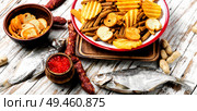 Selection of beer and snacks.Chips, fish, beer sausages on the table. Snacks for beer. Стоковое фото, агентство Ingram Publishing / Фотобанк Лори
