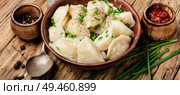 Dumplings is a Slavic dish, common in Ukrainian cuisine, in the form of boiled unleavened dough stuffed with vegetables. Dumplings with potatoes in plate. Стоковое фото, агентство Ingram Publishing / Фотобанк Лори