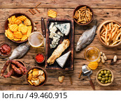 Large selection of snacks for beer. Set of cheeses, fish, chips and snacks.Selection food. Lager beer and snacks. Стоковое фото, агентство Ingram Publishing / Фотобанк Лори