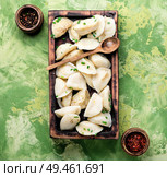 Dumplings is a Slavic dish, common in Ukrainian cuisine, in the form of boiled unleavened dough stuffed with vegetables. Ukrainian potato dumplings. Стоковое фото, агентство Ingram Publishing / Фотобанк Лори