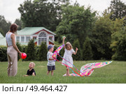 A family with three children. A mother with many children and toddlers in a summer park. Children are walking and flying a kite. Large families, family values, and leisure time with children. Стоковое фото, фотограф Photojuli / Фотобанк Лори