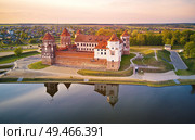 Aerial view of Medieval Mir castle complex at spring sunset. Famous landmark, UNESCO world heritage. Drone panorama of Mirsky zamok, Belarus. Стоковое фото, агентство Ingram Publishing / Фотобанк Лори