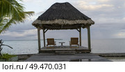 Pier with thatched roof structure, Caribbean Sea, Turneffe Island, Belize. Стоковое фото, агентство Ingram Publishing / Фотобанк Лори