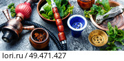 East smoking hookah with mint flavor.Shisha mint tobacco.Shisha hookah with spearmint. Smoking hookah with mint. Стоковое фото, агентство Ingram Publishing / Фотобанк Лори