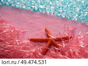 Microplastic pollution in ocean sea concept pink starfish on the beach. Стоковое фото, агентство Ingram Publishing / Фотобанк Лори