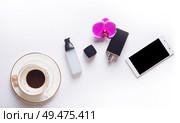 cup of coffee with smart  phone and lady care set around white background. life style flat lay. Стоковое фото, агентство Ingram Publishing / Фотобанк Лори