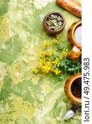 Cup with medicinal tea from Hypericum.Herbal medicine. Tea with Hypericum flowers. Стоковое фото, агентство Ingram Publishing / Фотобанк Лори