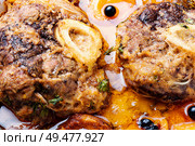 Ossobuco, traditional dish of Italian cuisine. Stewed veal leg. Ossobuco, beef with apricot. Стоковое фото, агентство Ingram Publishing / Фотобанк Лори
