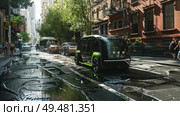 A city street bustling with heavy traffic flows alongside tall, modern buildings. The scene captures the urban hustle and bustle of a metropolitan area. Стоковое AI-изображение, AI-художник Данила Большаков / Фотобанк Лори