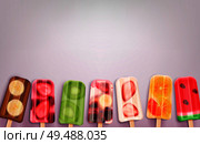 Fruit popsicles ice cream realistic background with images of frozen stick confections of different taste and flavour vector illustration. Стоковая иллюстрация, агентство Ingram Publishing / Фотобанк Лори