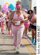 Group of women running in a race, sprinting towards the finish line with determination and focus. Стоковое AI-изображение, AI-художник Данила Большаков / Фотобанк Лори