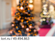 Beautiful Christmas background 2026.Abstract blurred Christmas background with Christmas tree garlands in warm shades. Стоковое фото, фотограф Photojuli / Фотобанк Лори