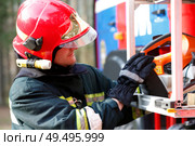 Firefighter retrieves fire hoses.The brave firefighter. Work of firefighter. Стоковое фото, фотограф Лазаренко Светлана / Фотобанк Лори