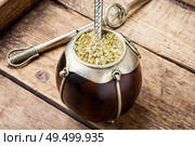 Yerba mate in calabash and dry herb.Traditional argentinian beverage. Yerba mate tea in a calabash gourd. Стоковое фото, агентство Ingram Publishing / Фотобанк Лори