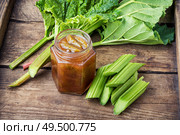 Rhubarb jam in jar and raw cut rhubarb.Rhubarb marmalade. Homemade rhubarb jam. Стоковое фото, агентство Ingram Publishing / Фотобанк Лори