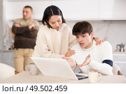 Young woman calms guy sitting with laptop. Стоковое фото, фотограф Яков Филимонов / Фотобанк Лори