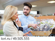 choosing chocolate truffles in gold gift box. Стоковое фото, агентство Ingram Publishing / Фотобанк Лори