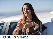 Young woman applying sunscreen on her face in snowy mountains in winter, in Sierra Nevada, Granada, Spain. Female wearing winter clothes.. Young woman applying sunscreen on her face in snow landscape. Стоковое фото, агентство Ingram Publishing / Фотобанк Лори
