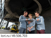 workers next to ventilator in factory with cloud and sky. Стоковое фото, агентство Ingram Publishing / Фотобанк Лори