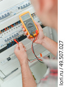 man is using a multi meter. Стоковое фото, агентство Ingram Publishing / Фотобанк Лори