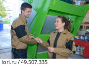 couple of workers in coveralls near machines at factory. Стоковое фото, агентство Ingram Publishing / Фотобанк Лори