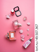 lady set with cosmetics and flowers around pink background. flat lay. Стоковое фото, агентство Ingram Publishing / Фотобанк Лори