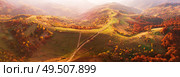 Autumn mountain panorama. Sunny landscape with meadow and colorful forest. Red, Yellow, Orange trees on hillsides. National Natural Park Synevyr, Carpathians, Ukraine, Europe. Стоковое фото, агентство Ingram Publishing / Фотобанк Лори