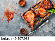Spicy meat grilled spare ribs on wooden cutting board. Pork ribs grilled. Стоковое фото, агентство Ingram Publishing / Фотобанк Лори