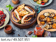 Grilled sausages fried with pear and vegetables. Autumn food.. Grilled sausages with vegetables. Стоковое фото, агентство Ingram Publishing / Фотобанк Лори