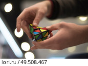 man collects the cube rubik. Intellectual puzzle. Редакционное фото, агентство Ingram Publishing / Фотобанк Лори
