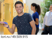 student next to lockers at uni. Стоковое фото, агентство Ingram Publishing / Фотобанк Лори