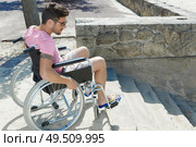 man in the wheelchair trying to find solution for stairs. Стоковое фото, агентство Ingram Publishing / Фотобанк Лори