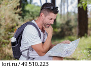 hiker with map exploring wilderness on trekking adventure. Стоковое фото, агентство Ingram Publishing / Фотобанк Лори