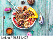 Grilled veal with vegetables to the Christmas table.Christmas food.Veal in pomegranate sauce.. Christmas grilled meat. Стоковое фото, агентство Ingram Publishing / Фотобанк Лори