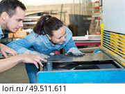 male and female workers in metalworks factory. Стоковое фото, агентство Ingram Publishing / Фотобанк Лори