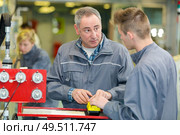 two careful workmen working at a factory. Стоковое фото, агентство Ingram Publishing / Фотобанк Лори